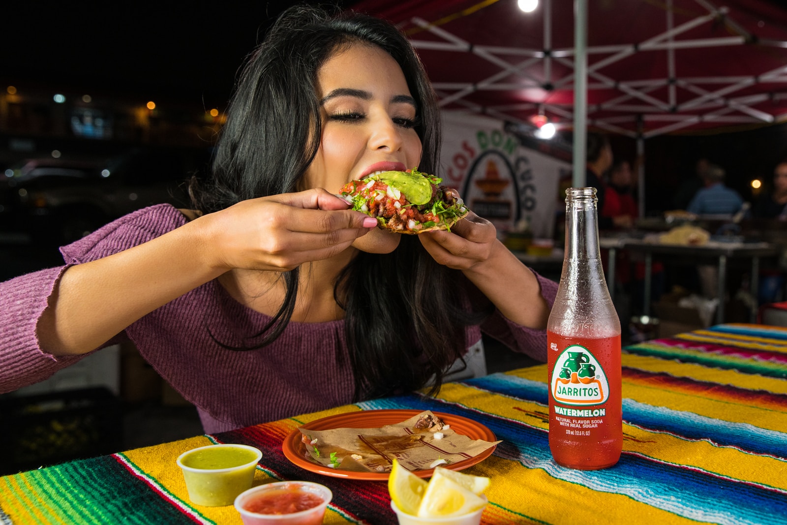 Photo by Jarritos Mexican Soda woman in purple shirt holding green and yellow floral ceramic bowl